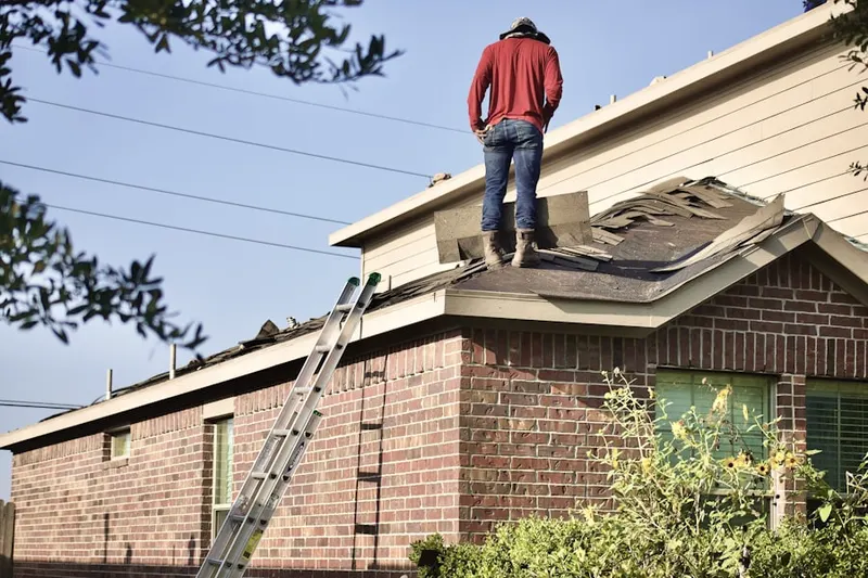 Professional roofer working on a residential roof in West Bremen